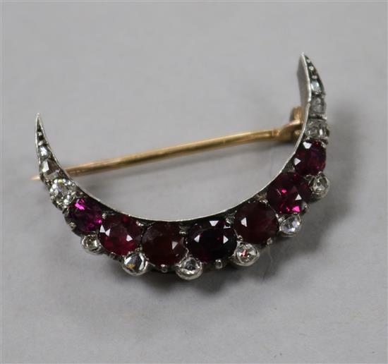 An early 20th century yellow and white metal, diamond and gem set crescent brooch, 30mm.